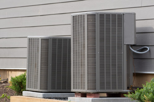 Two AC units behind a home in Shawnee